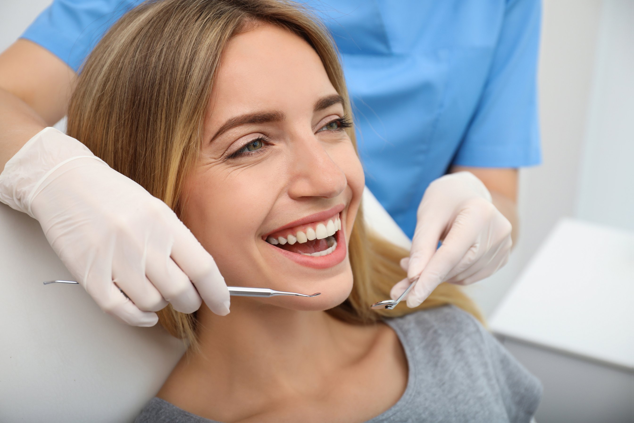 Doctor Examining Patient's Teeth in Clinic, Closeup. Cosmetic Dentistry