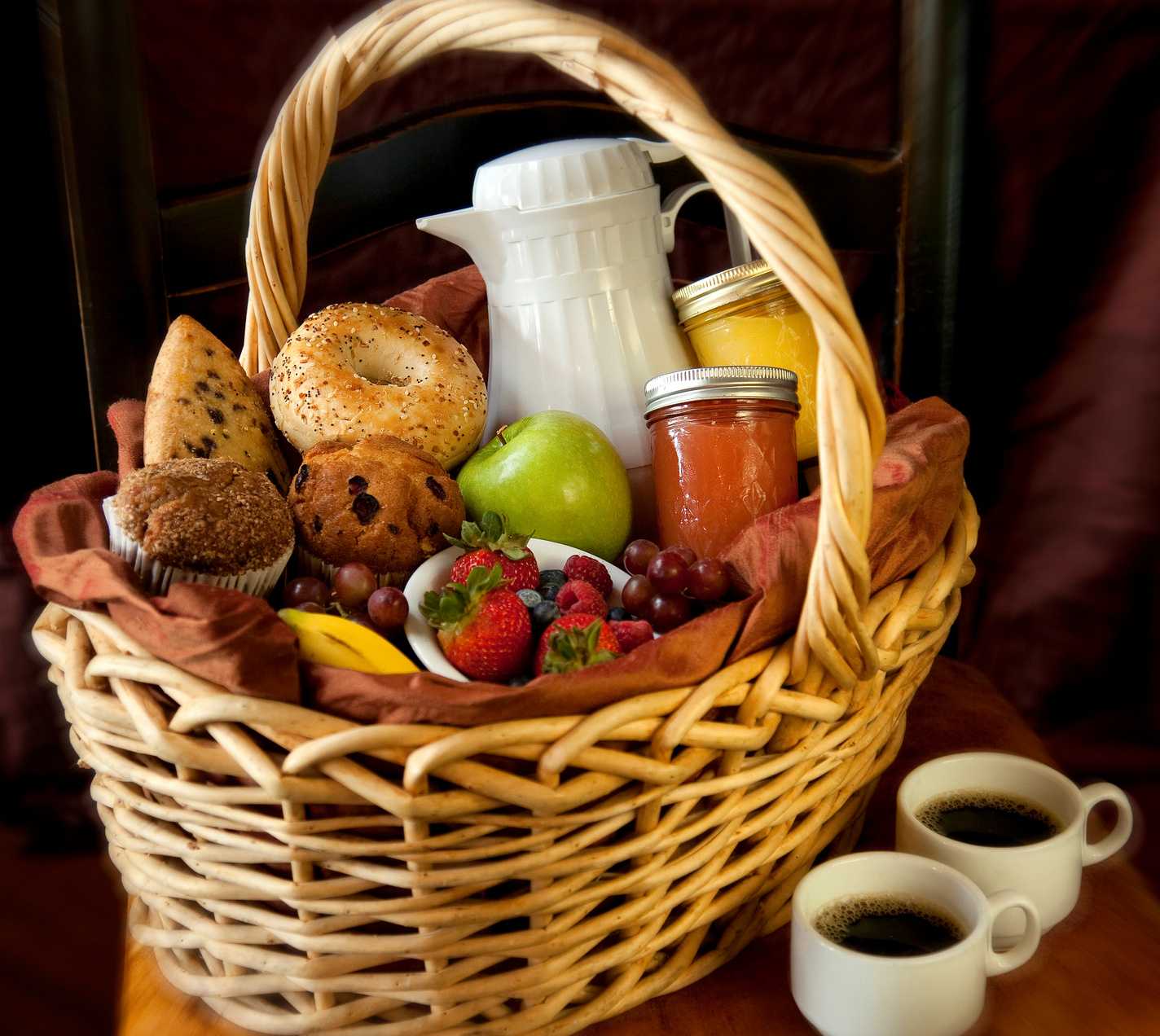 Basket full of breakfast food, coffee, and Juices. Breakfast in Bed