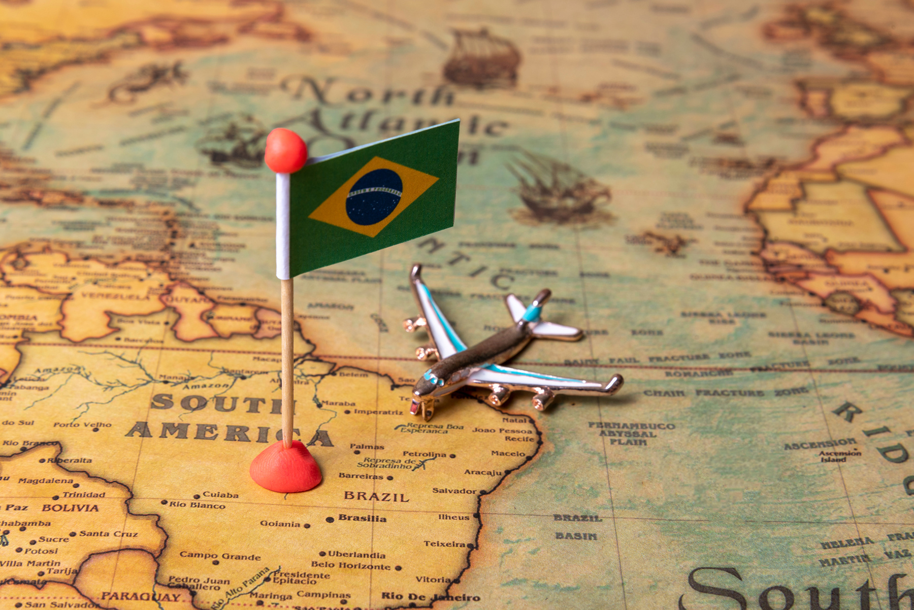 The flag of Brazil and the plane on the world map.