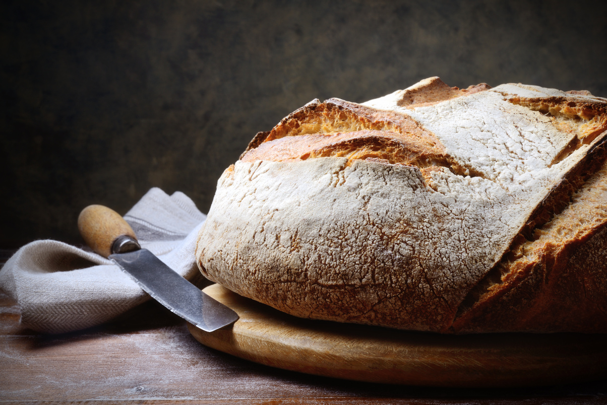 Naturally leavened bread, loaf of traditional bread, closeup, space for text.